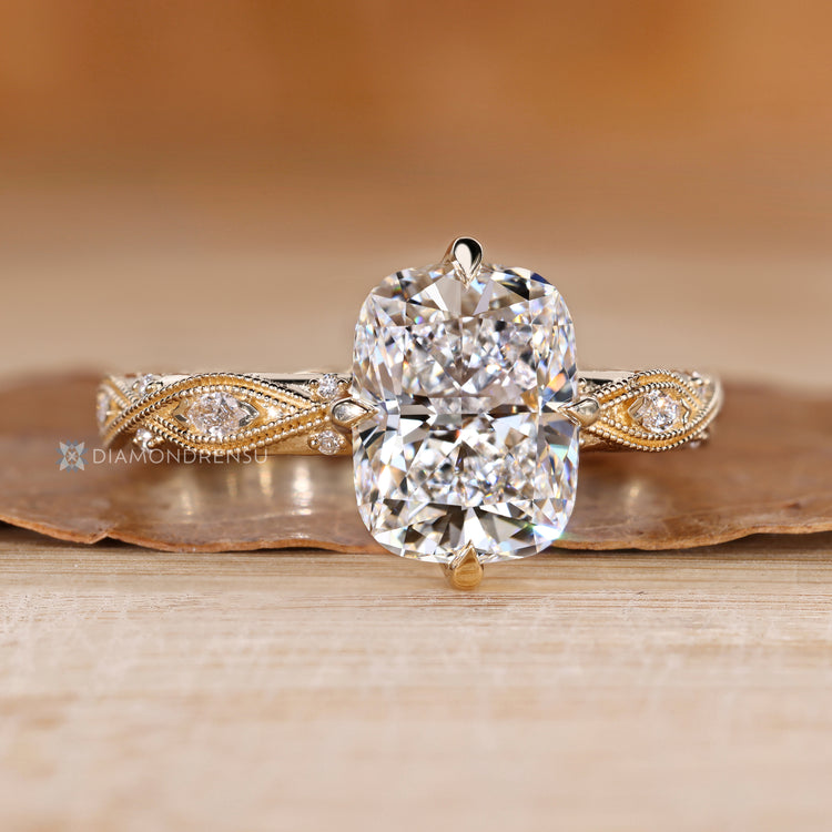 Lab grown cushion diamond ring with compass claw prongs.