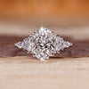 Oval cut lab grown diamond ring with marquise side stones.