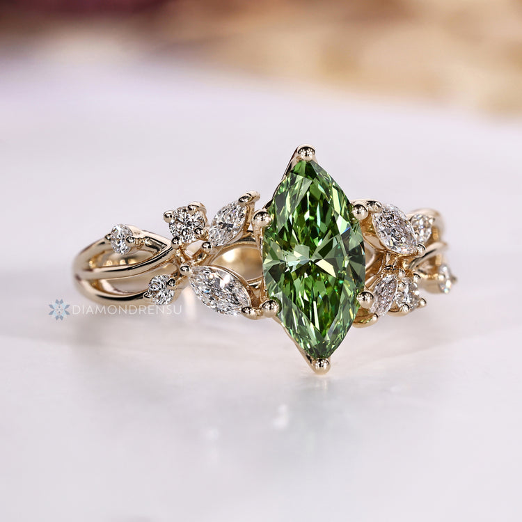 Green centre diamond ring with six prong setting.