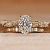 Oval cut engagement ring with round and marquise side stones.