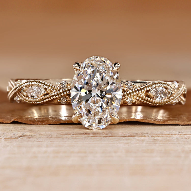 Oval cut engagement ring with round and marquise side stones.