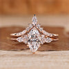 Marquise wedding ring with marquise and round side stones.