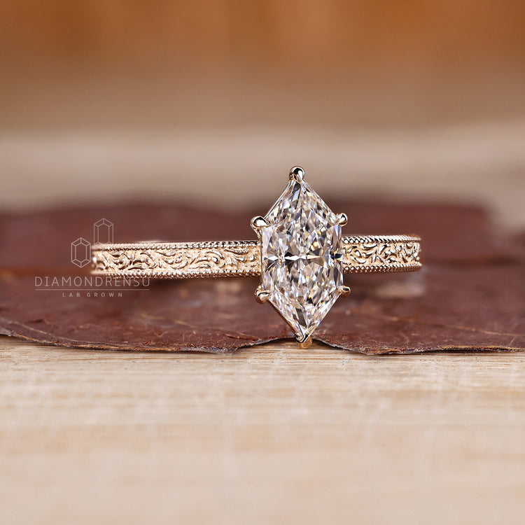 Lab grown marquise diamond ring with six claw prongs.