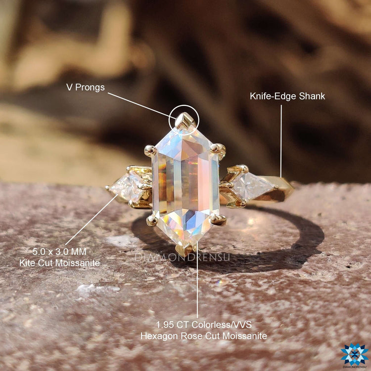 Unique three stone ring with kite side accents.
