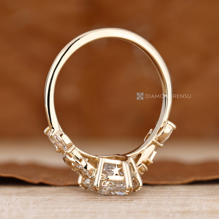 Nature inspired ring with round and marquise side stones.