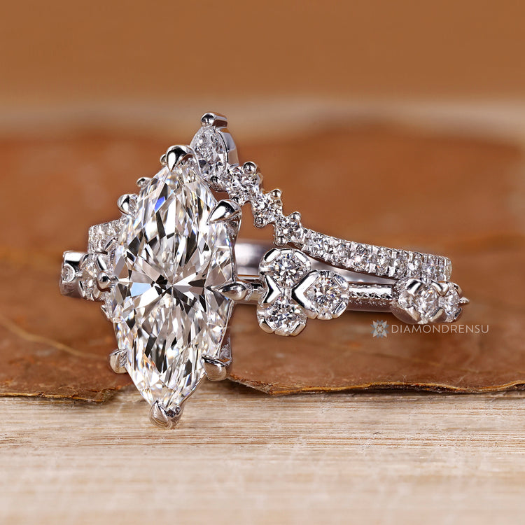 Handmade marquise ring with curvy band and round diamonds.