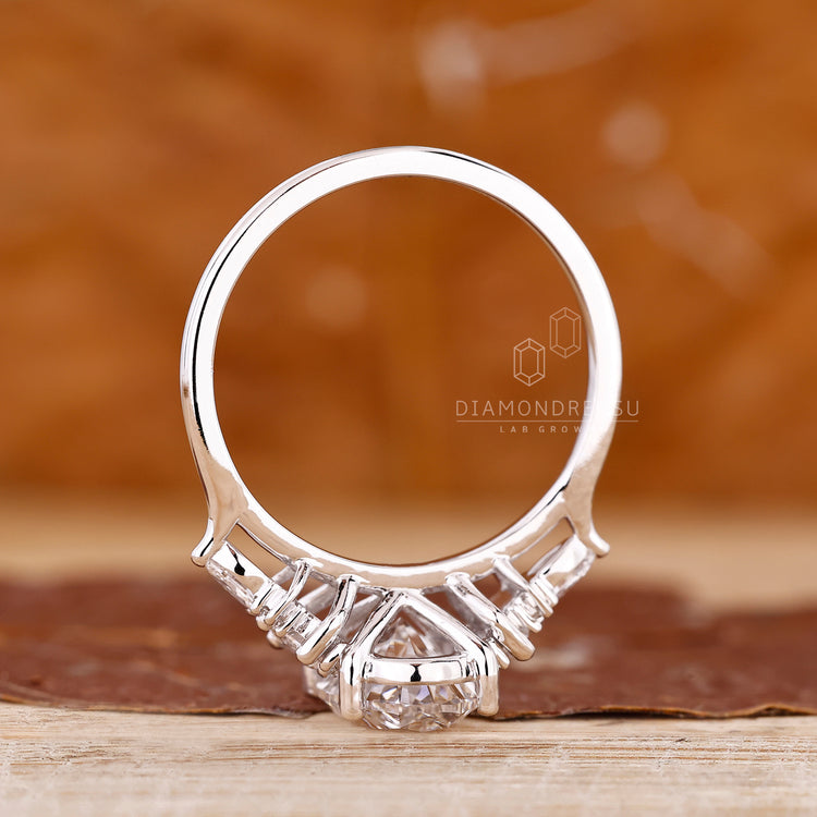 Diamondrensu oval ring with marquise and round accents.