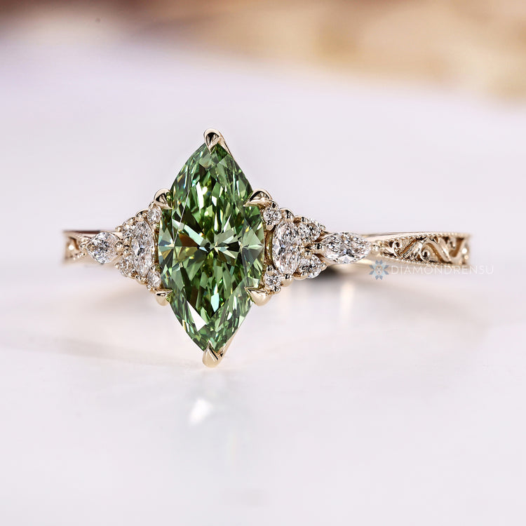 Marquise cut ring with green centre and side stones.