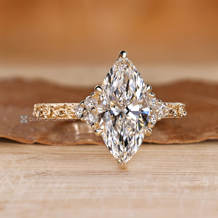 Handmade marquise engagement ring with round side stones.