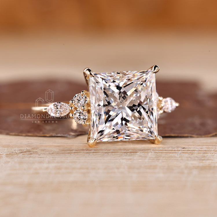 Princess cut ring with marquise and round side stones.