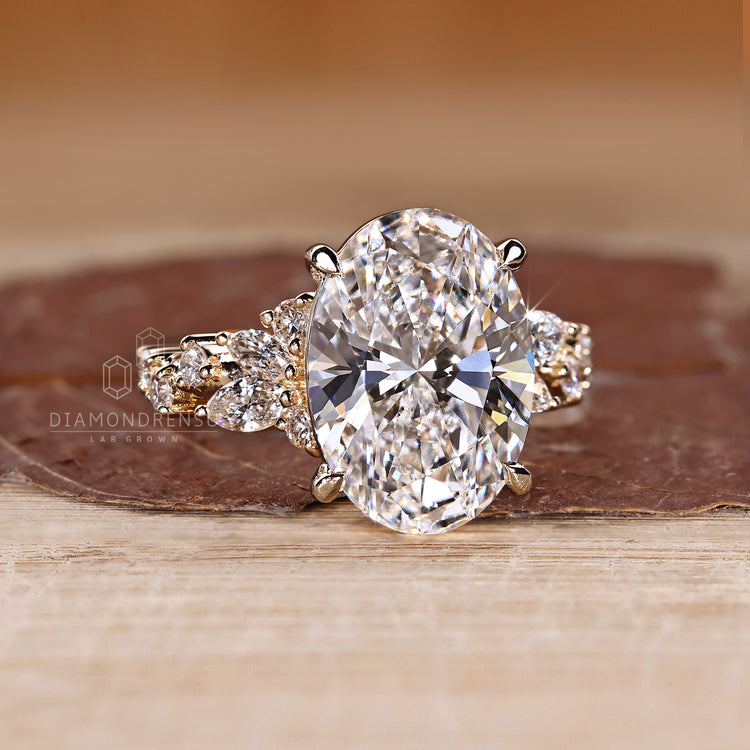 Handmade oval diamond ring with four claw prongs.
