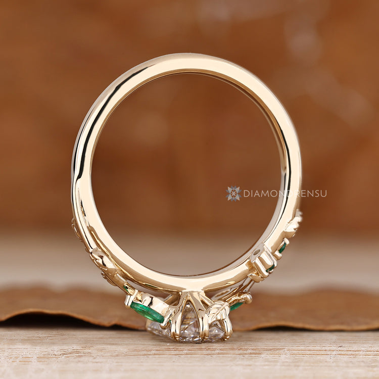 Handmade nature inspired engagement ring with green emeralds.