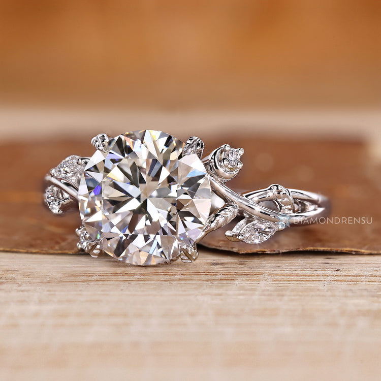 Round diamond ring with four leaf prong setting.