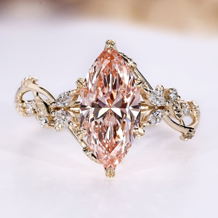 Marquise cut engagement ring with pink centre diamond.