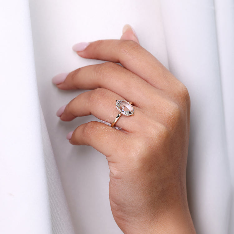 Oval rose cut diamond ring with compass prong setting.