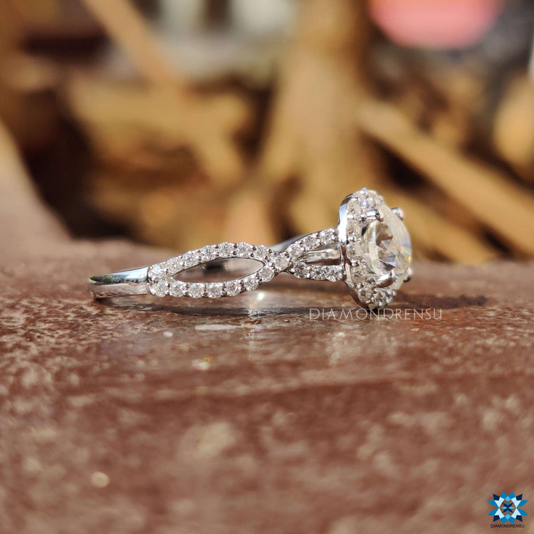 White gold engagement ring with twisted pave band.
