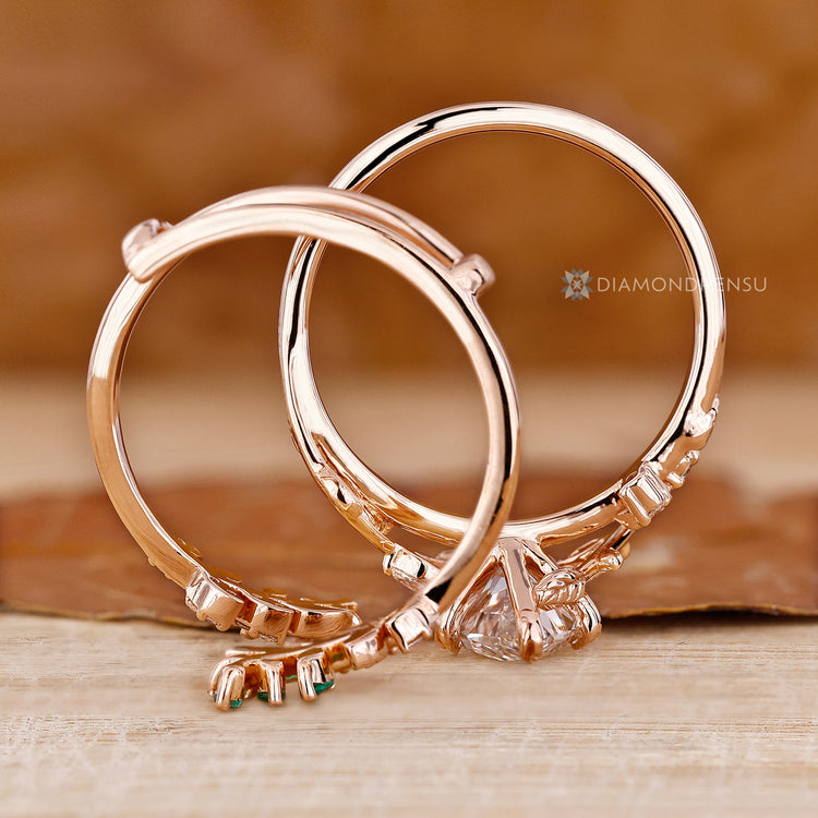 Nature inspired band with emerald and marquise diamonds.