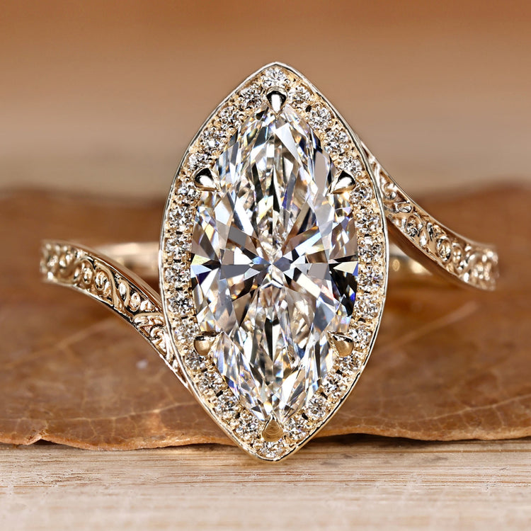 Pavé engagement ring with marquise cut diamond.