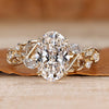 Oval cut engagement ring with marquise and round side stones.
