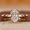 Oval cut lab grown diamond ring with triple prong setting.