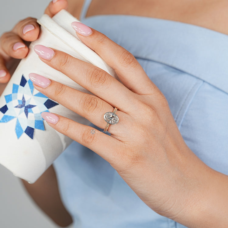 Handmade oval diamond ring with cathedral setting.