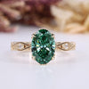 Oval cut diamond ring with green centre diamond.