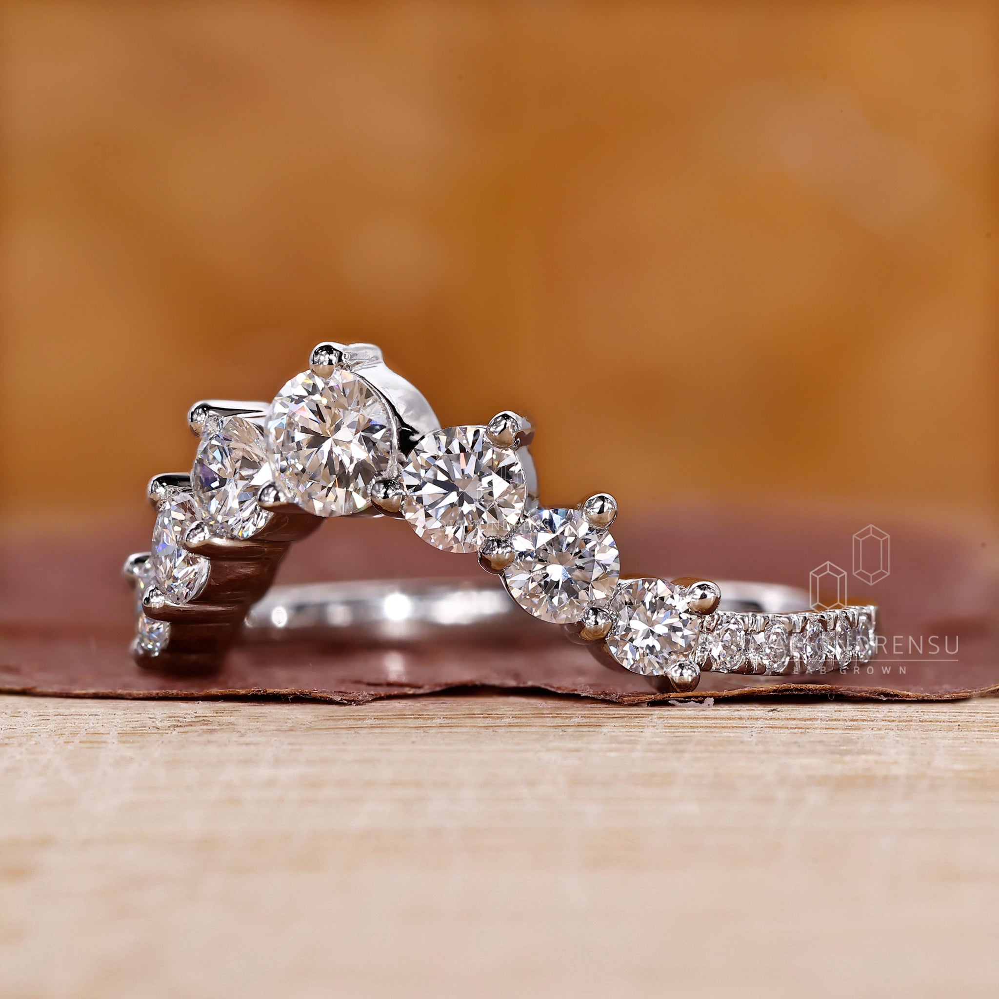 Prong set wedding band designed with a modern U shaped contour.