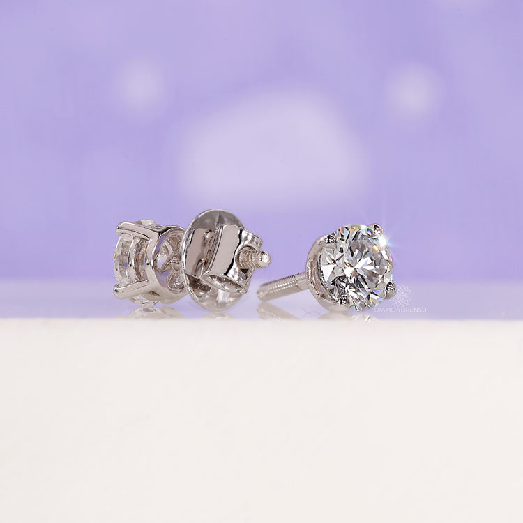 Screw back round diamond earrings.