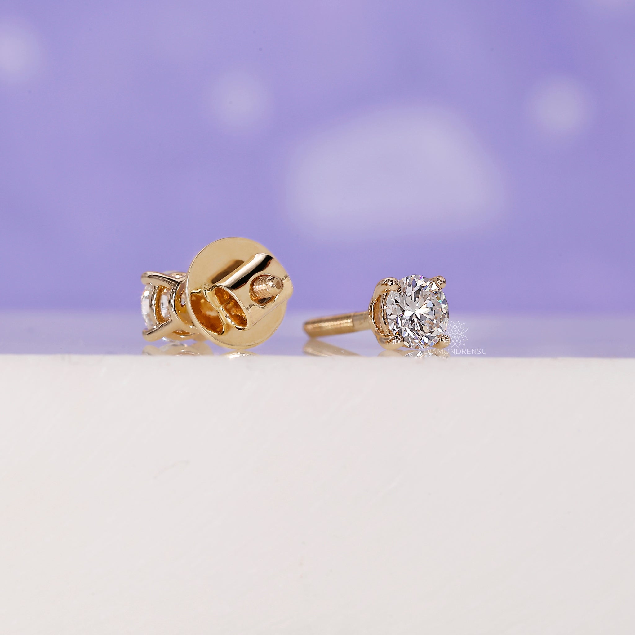 Screw back round diamond earrings.