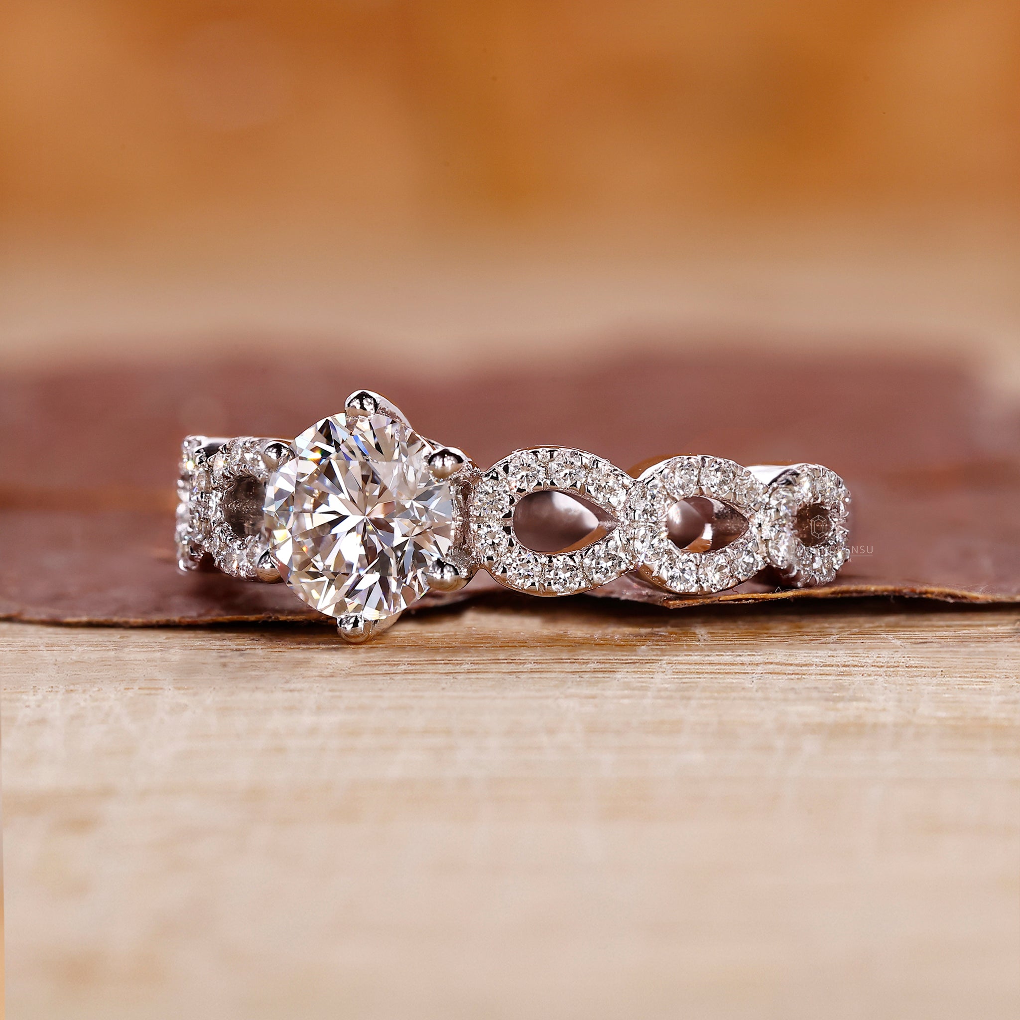 Round diamond ring set in a twisted pave band with white gold detail.
