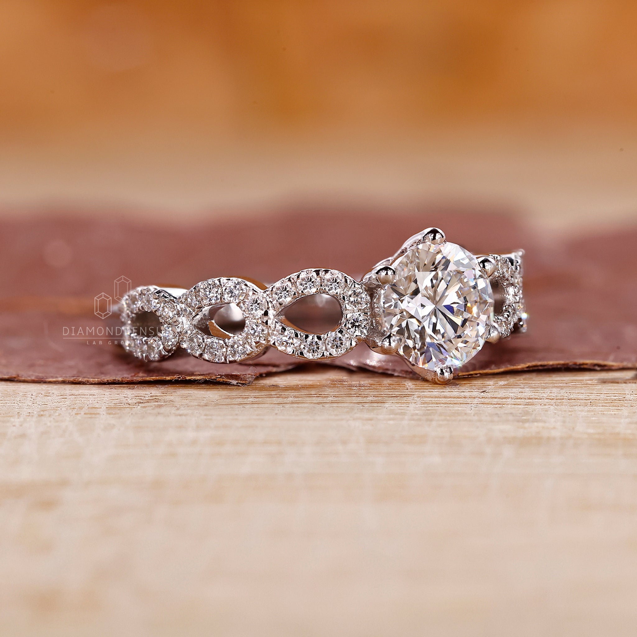 Diamondrensu UK engagement ring in white gold with round cut pave band.
