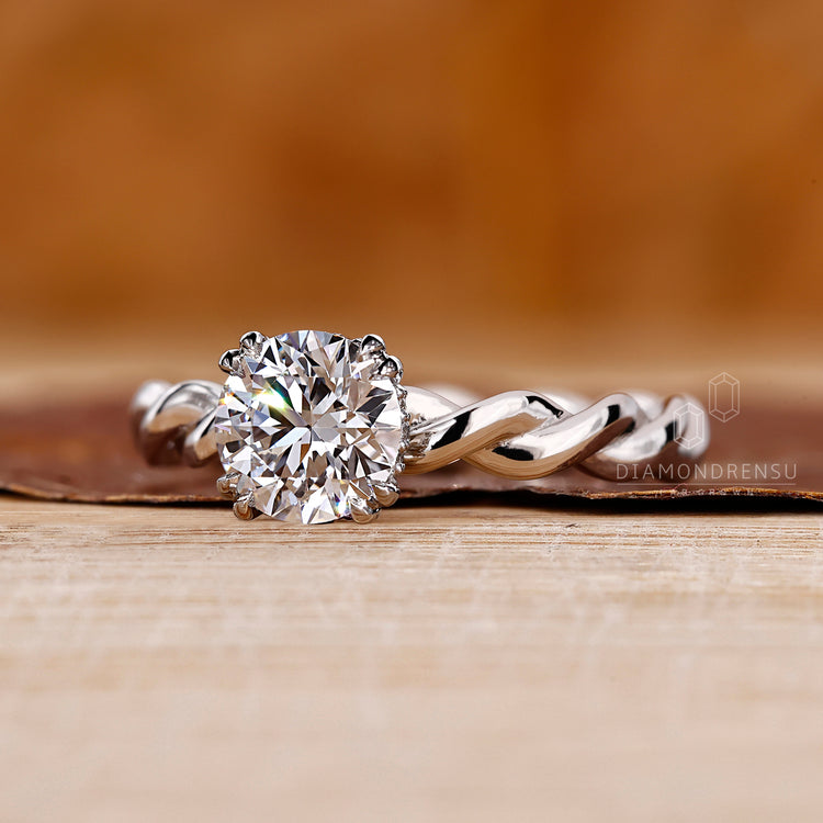 White gold ring with hidden halo and round diamond.
