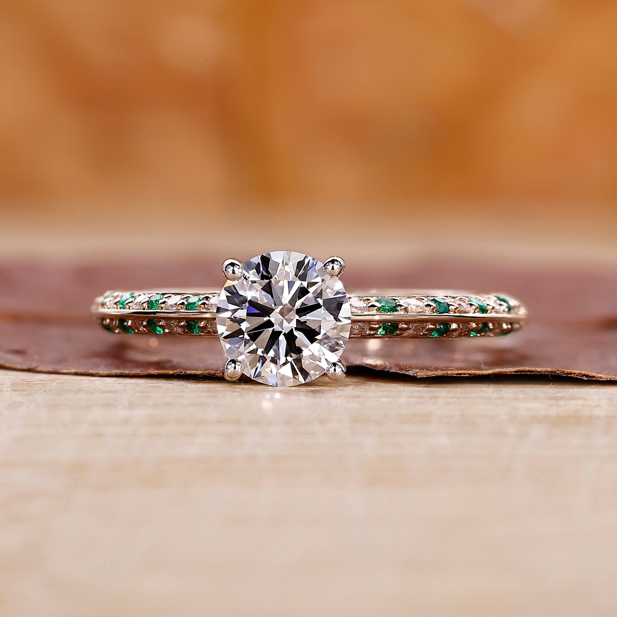 Knife Edge Ring with emerald round cut diamond center.

