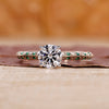 Knife Edge Ring with emerald round cut diamond center.

