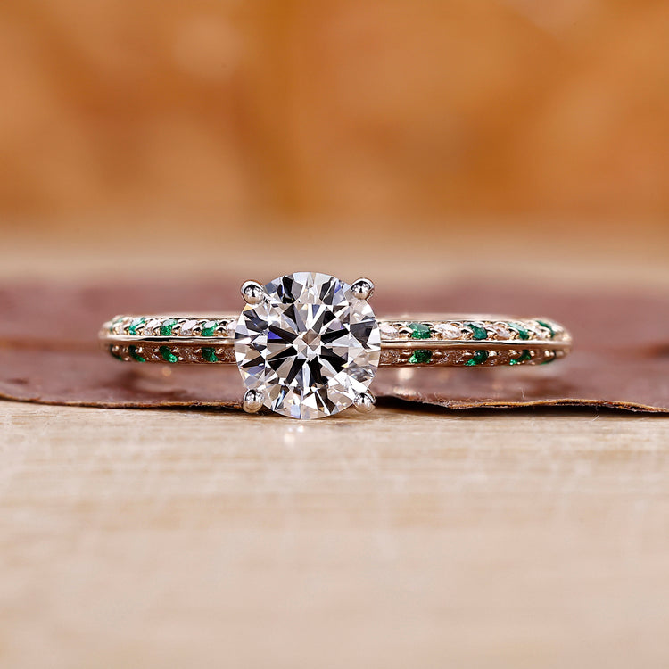 Knife Edge Ring with emerald round cut diamond center.
