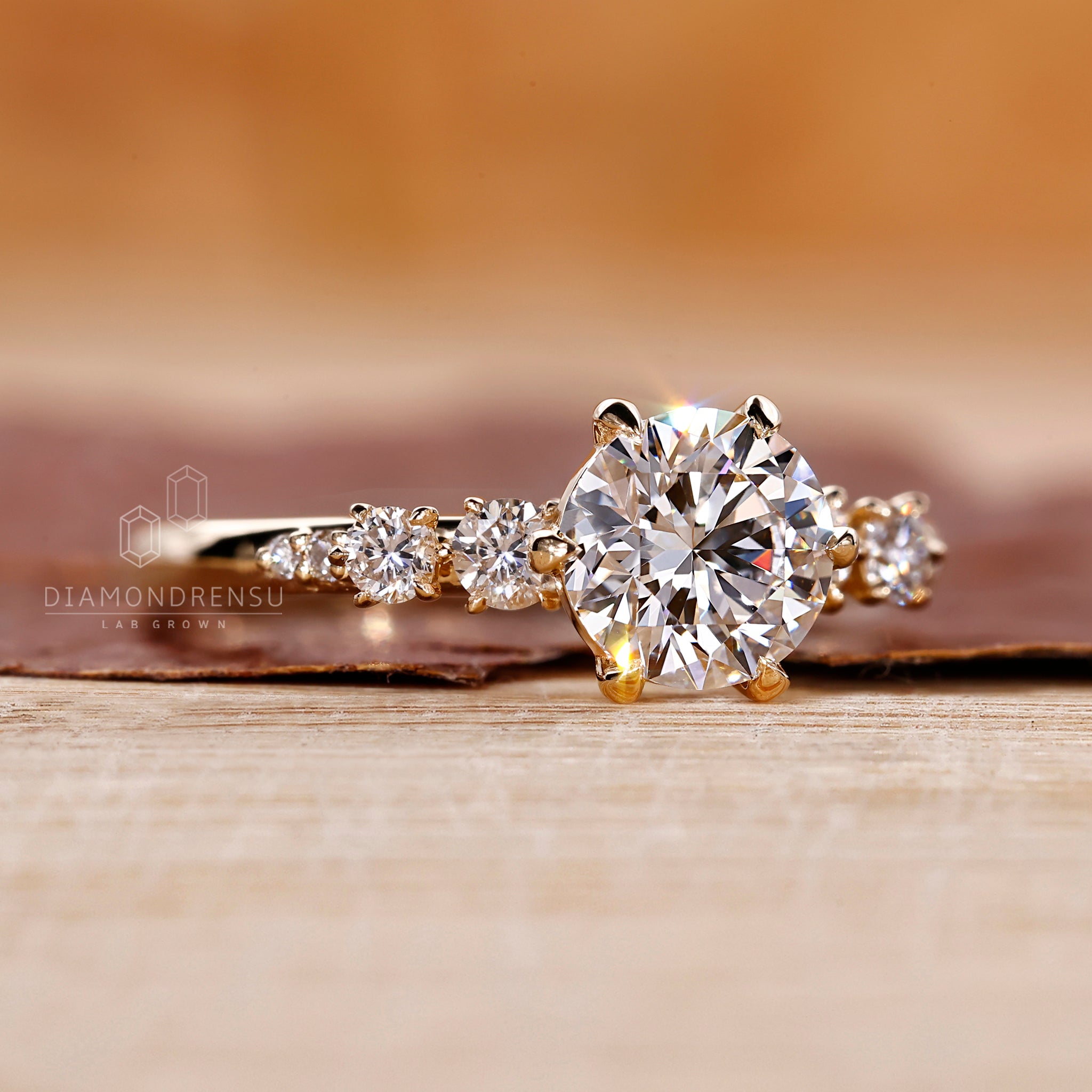 Lab diamond ring with round diamond side stones.