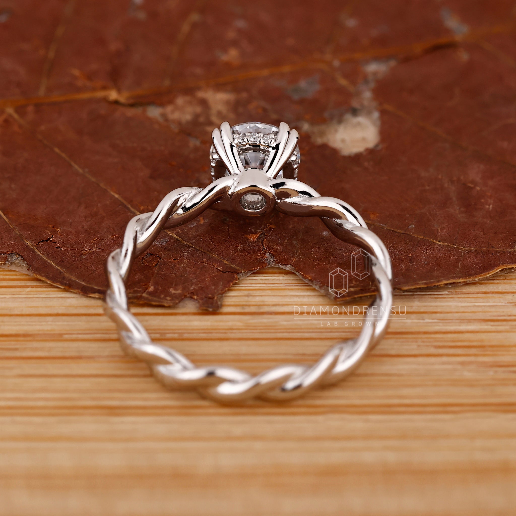 Unique ring with twisted shank and halo detail.

