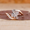 Bypass setting ring with pear cut diamond center.

