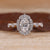 Oval halo ring with marquise shape outline.

