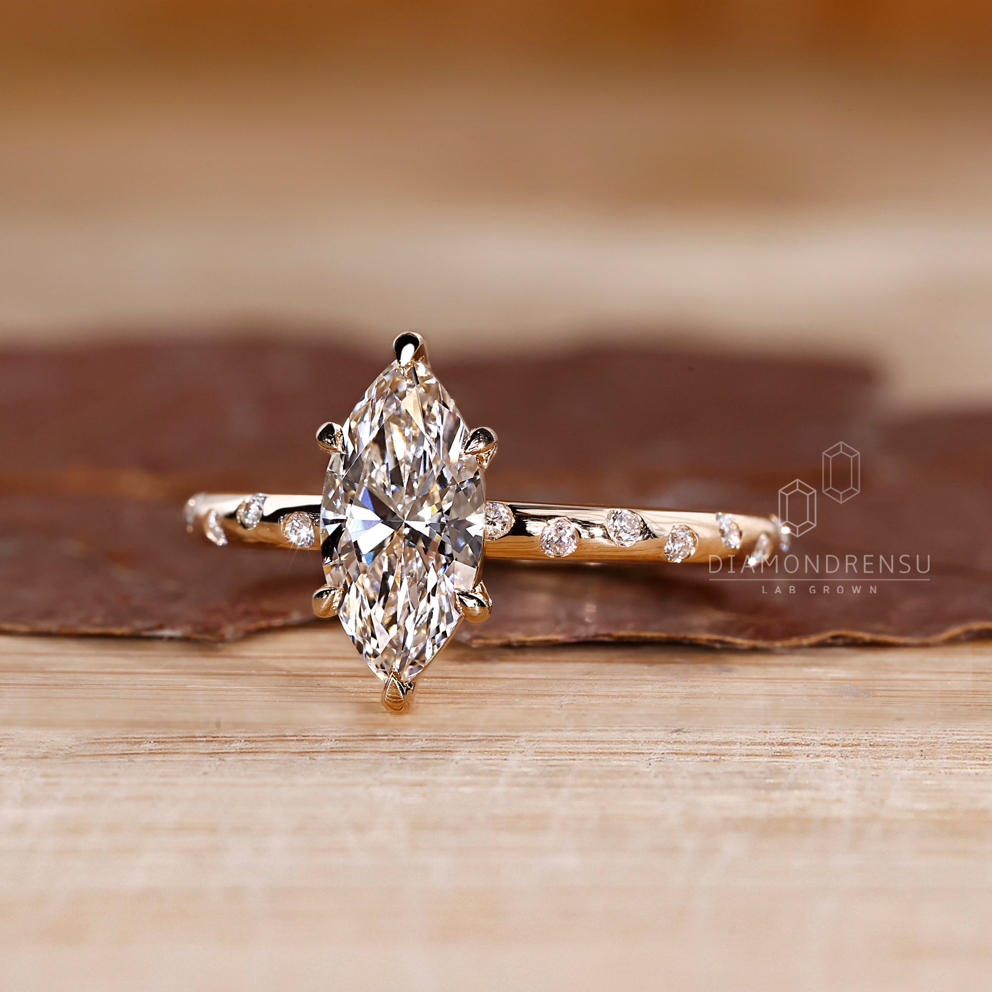 Flush pave band paired with a marquise center.
