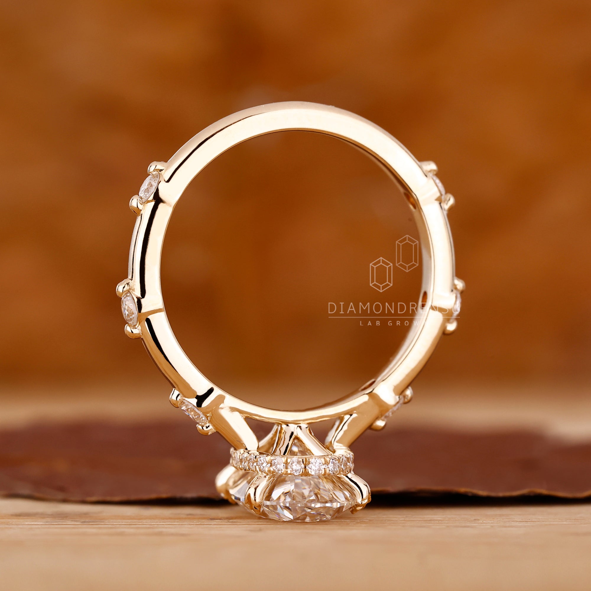 Yellow gold engagement ring with leaf prong detail.
