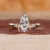 Yellow gold marquise diamond engagement ring with tapered shank band.
