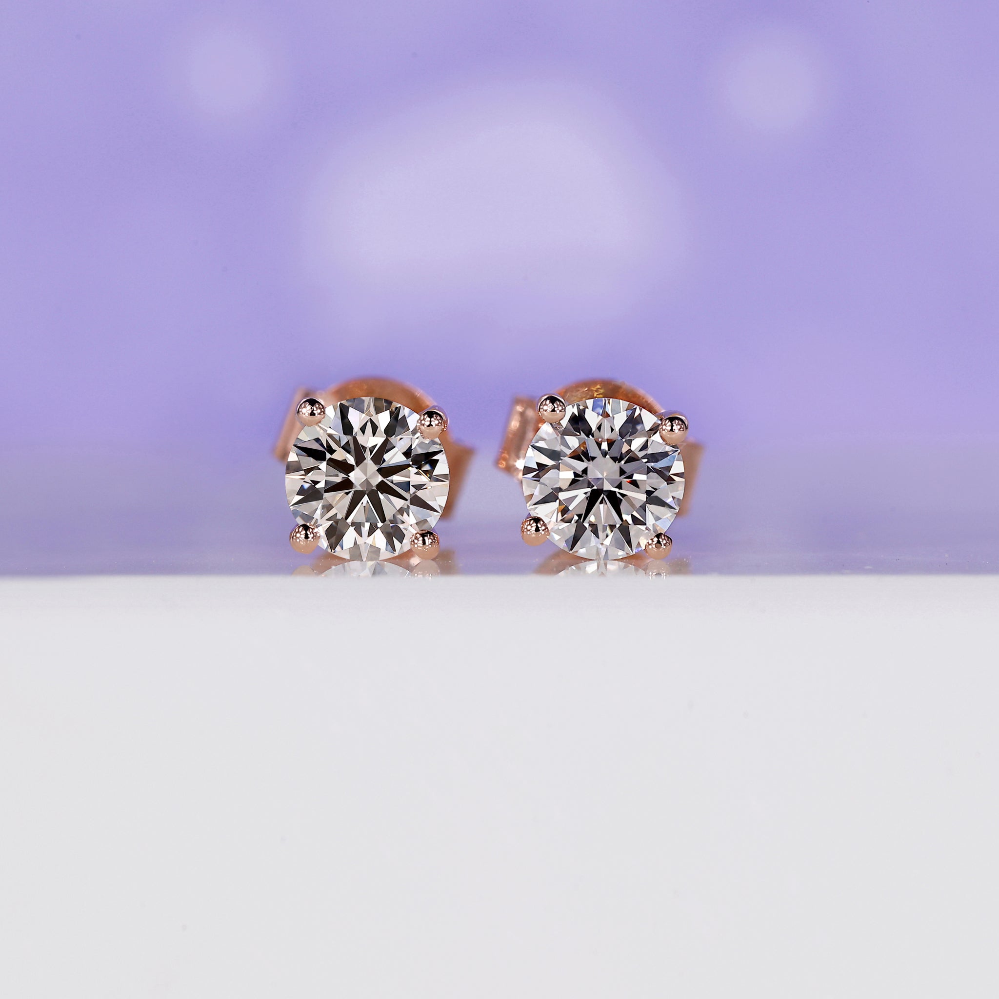 Rose gold stud earrings with round lab grown diamonds in prong setting.
