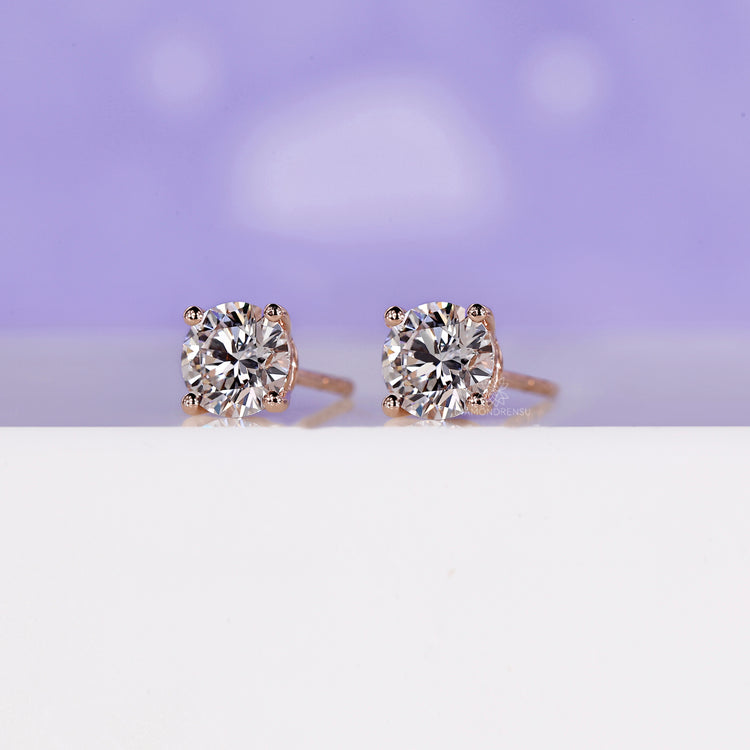 Lab grown diamond earrings set in rose gold prong settings.