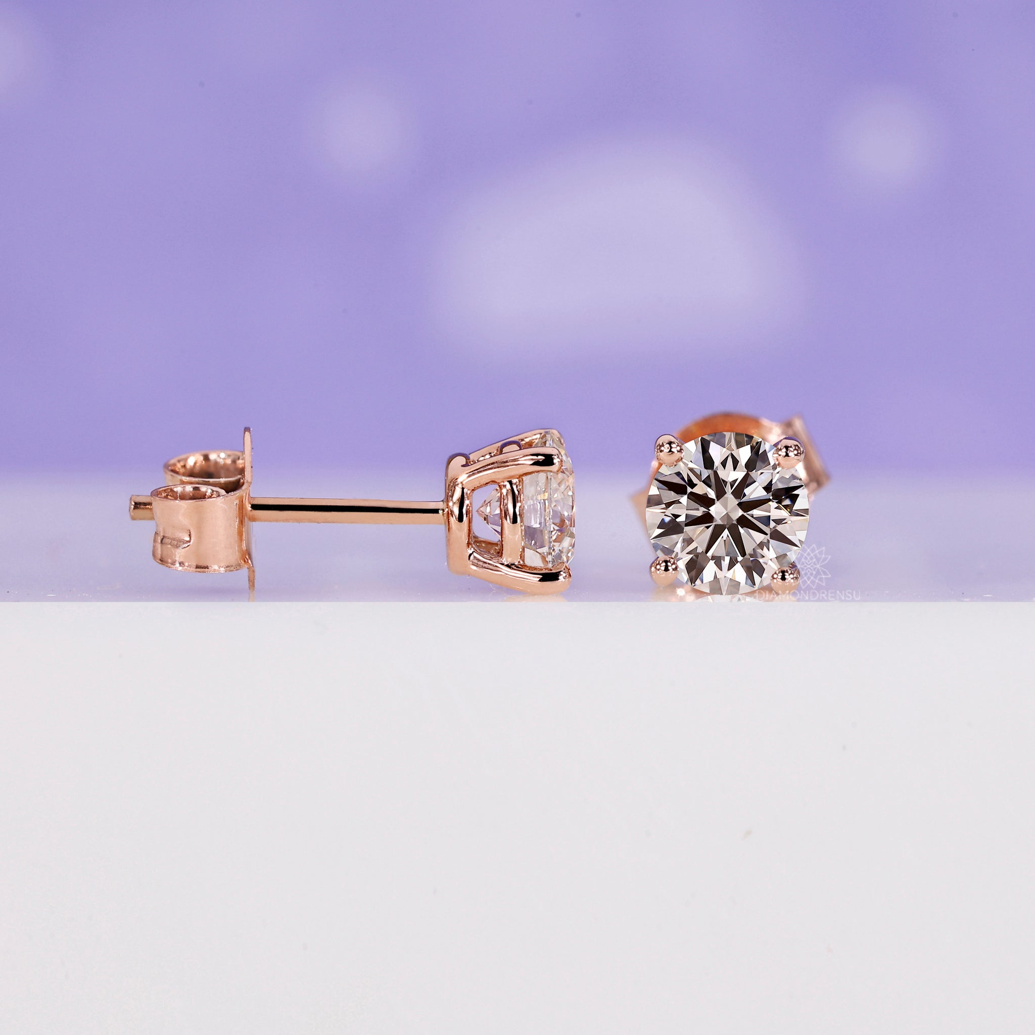 Elegant handmade earrings with round lab grown diamonds in rose gold.