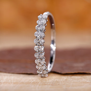 Oval diamond wedding band crafted in white gold with a sleek finish.
