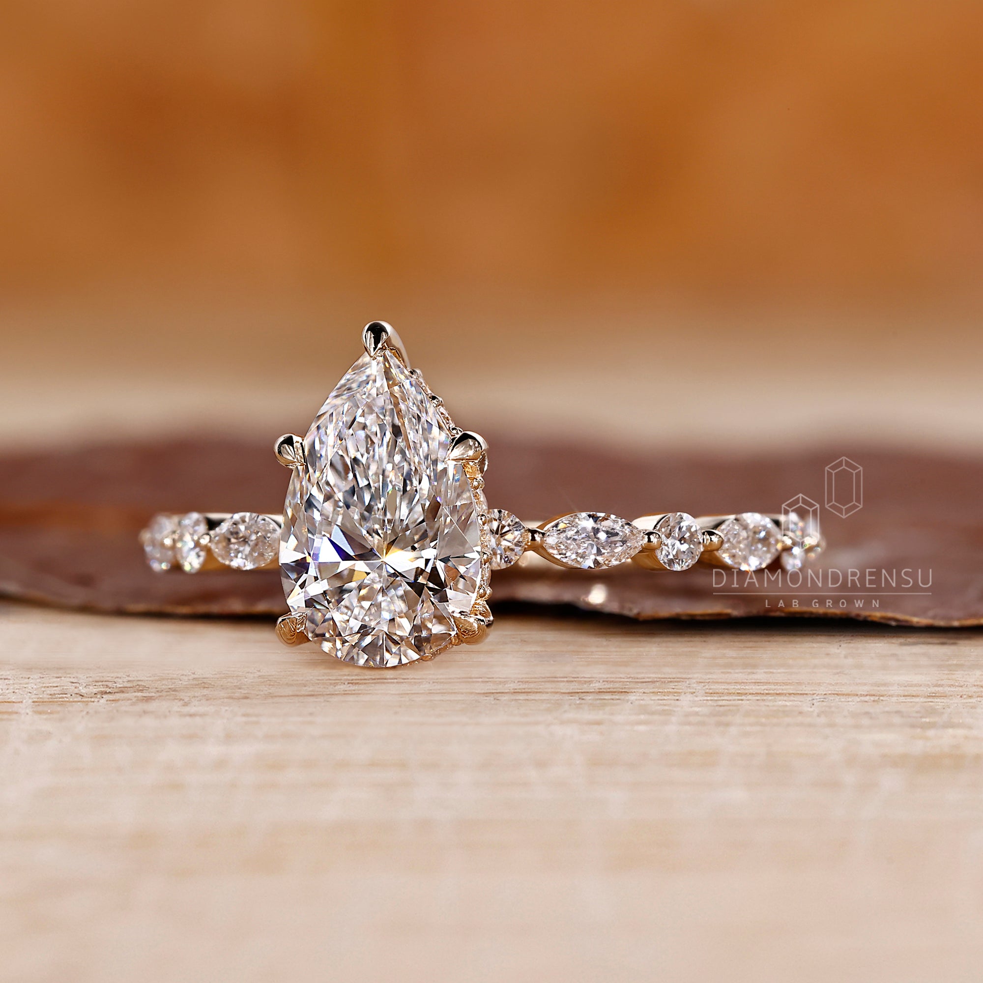 5 claw prong ring featuring a pear shaped center.
