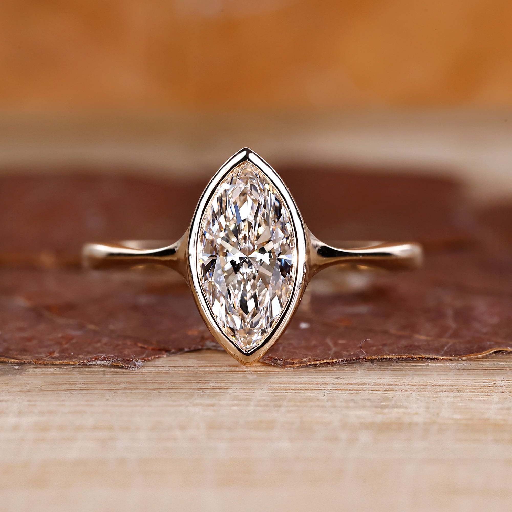 Bezel set engagement ring with a smooth modern edge.
