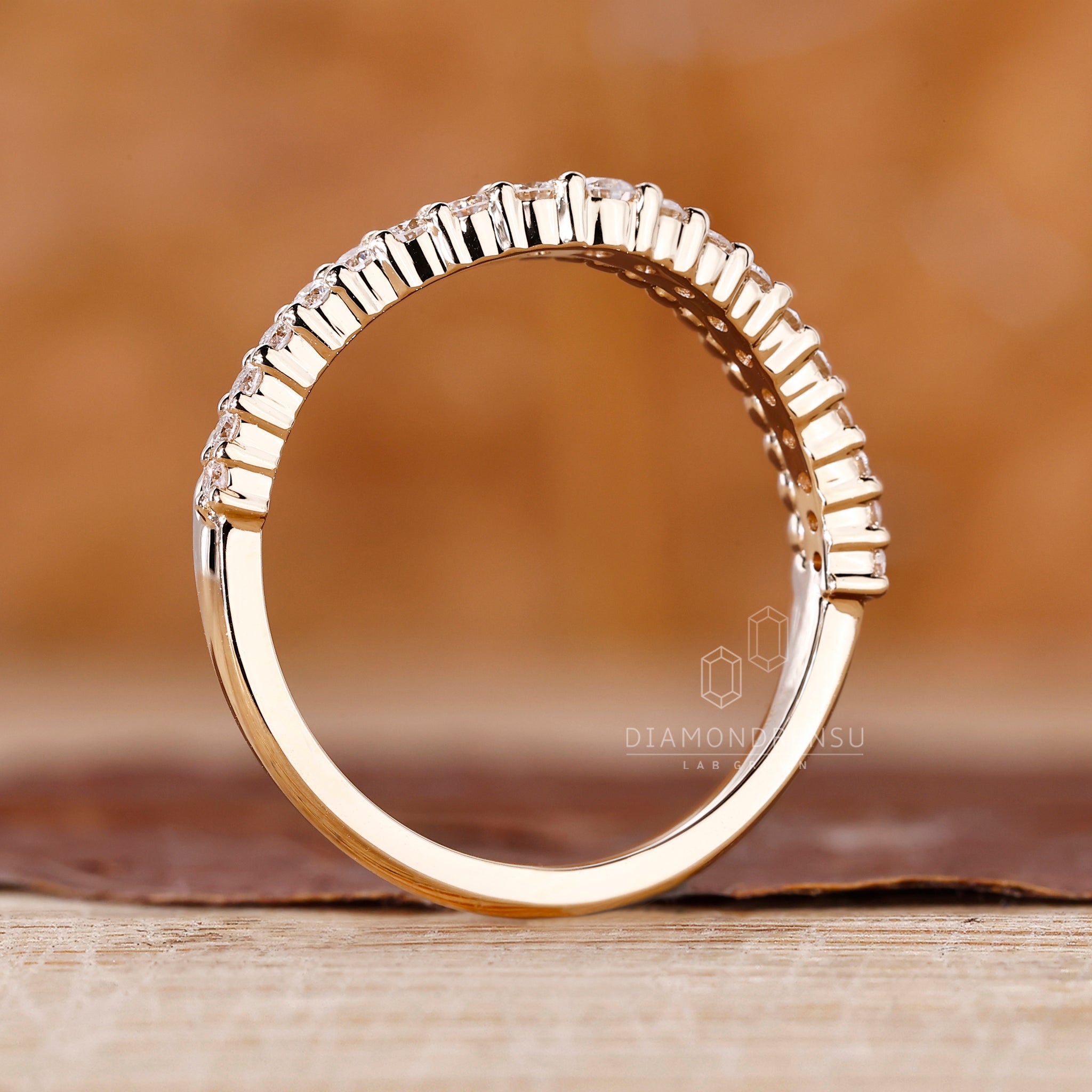 Custom diamond band with prong setting in yellow gold.