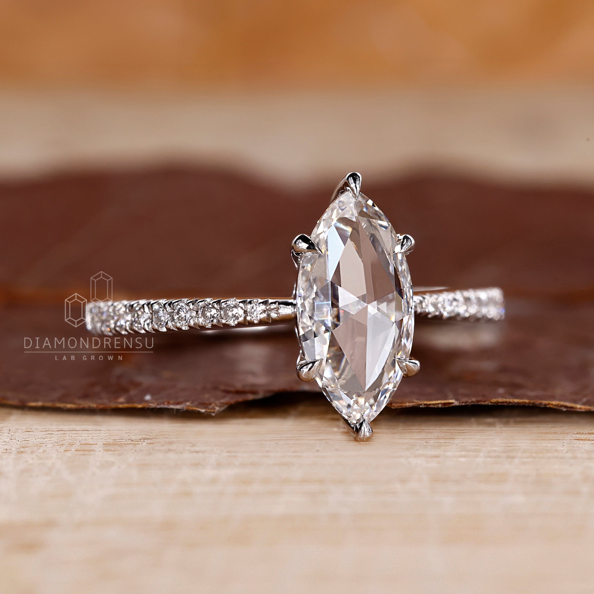 White gold ring featuring a marquise rose cut diamond.
